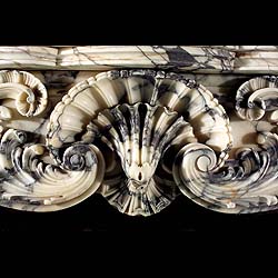 A large antique Rococo Sienna Claire marble fireplace surround    