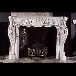 An antique Rococo Revival marble fireplace surround 