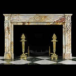 Antique Louis XVI Marble Regency fireplace with carved floral Cartouche
 This large figured Marble Regency Chimneypiece has a breakfronted shelf  with a simple frieze. The central floral Cartouche is highly carved and is flanked by floral Paterae carved into the endblocks. The substantial jambs are adorned with Acanthus leaf detail with scrolled consoles. French 19th century.
