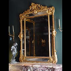Antique Large Louis XIV Gilded Pine Mirror with large Cartouches and detailed edging
 This Gilded Pine French Mirror has the original glass surrounded by ornate edging and large shell cartouches, French 19th century Louis XIV manner.

