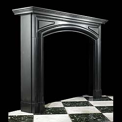 An Antique Baroque style Belgiam Black marble bolection fireplace surround