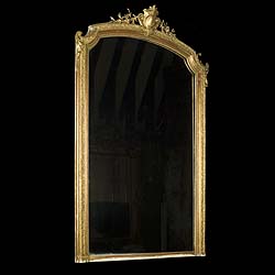 An Antique French Regence style giltwood and gesso overmantel mirror 