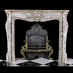A Louis XV style Rococo breche violette marble chimneypiece 