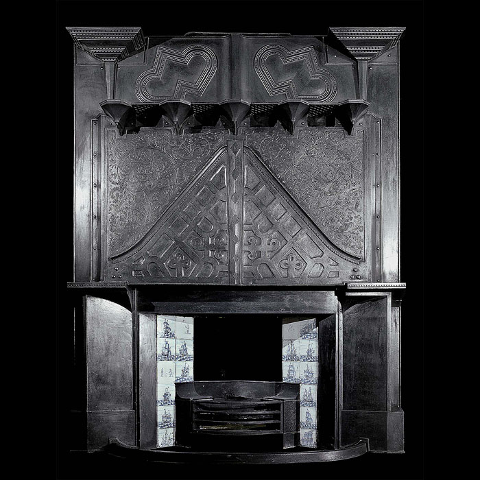 An antique cast iron Arts & Crafts fireplace mantel 