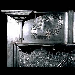 An antique cast iron Arts & Crafts fireplace mantel 
