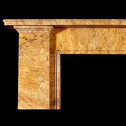 An antique Egyptian Revival Sienna Marble fireplace surround.