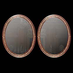 Antique Pair of Oval Mirrors in Bronze with floral adornment 
 This pair of French Oval mirrors have ornate floral decoration in Bronze. Early 20th century.

