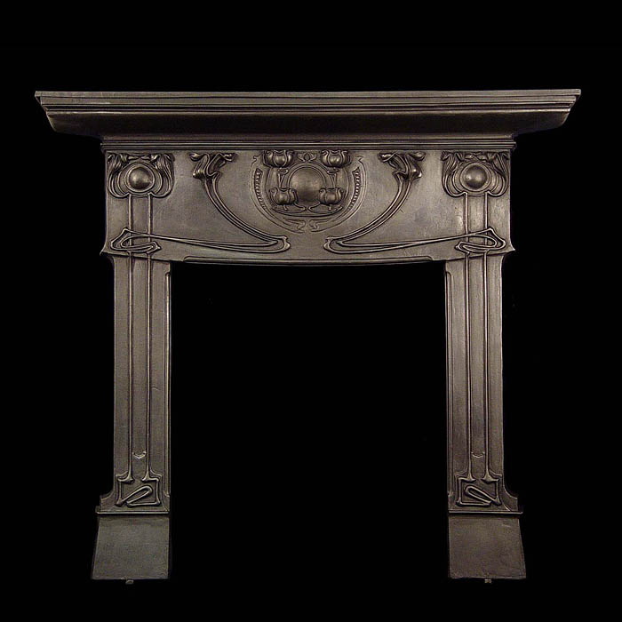 An Art Nouveau cast iron Voysey style fireplace surround    