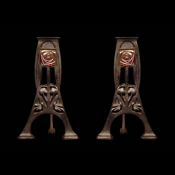 A pair of cast iron Art Nouveau antique fire dogs    