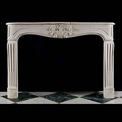 Antique Louis XV Stone Rococo Chimneypiece with fluted jambs 
 An antique Rococo Fireplace in the French style of Louis XV with a central cartouche, flanked by a panelled frieze, supported on fluted jambs. Carved in Stone.
