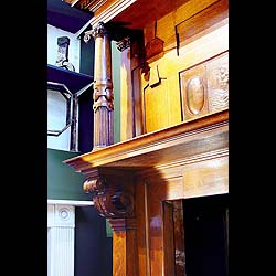 An antique Arts & Crafts oak inlaid fireplace surround   