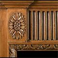A carved pine Neoclassical style fire surround