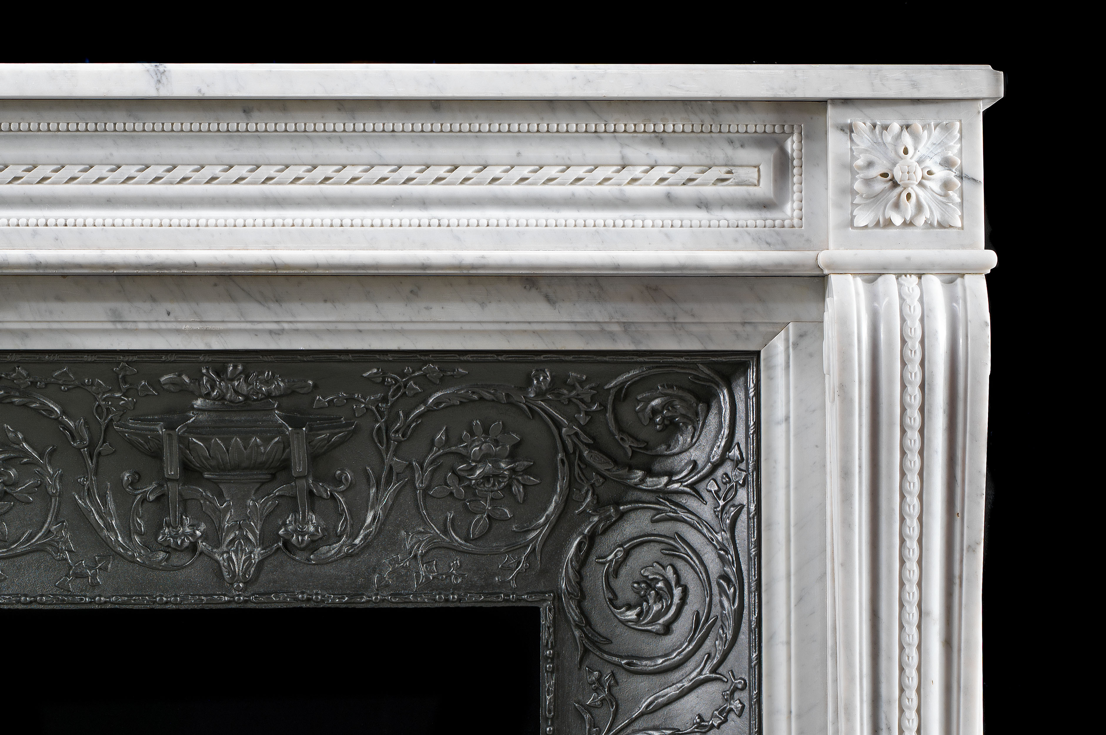A French Louis XVI style antique marble fireplace and insert.