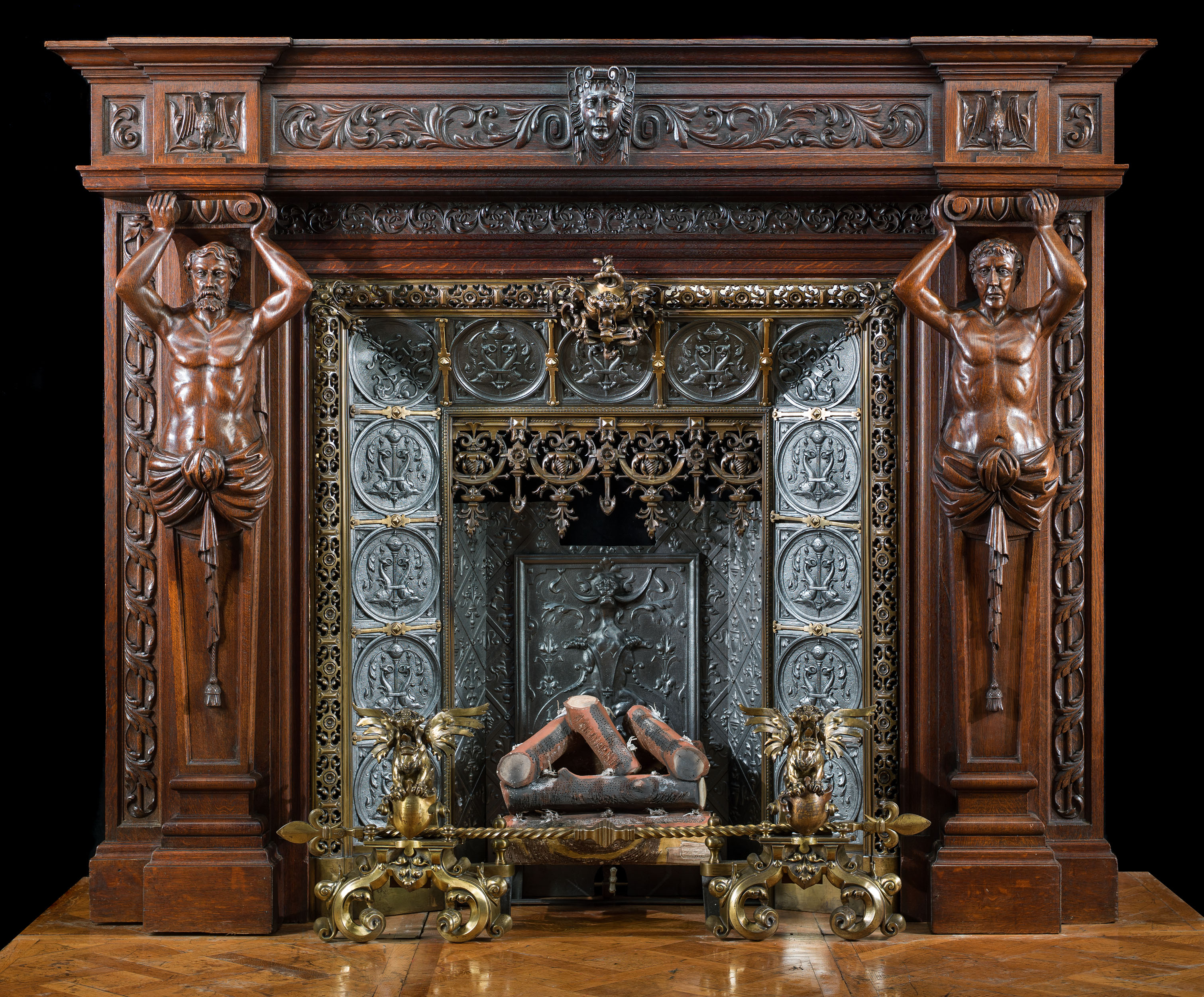 A large French carved Oak Renaissance style fireplace and insert.