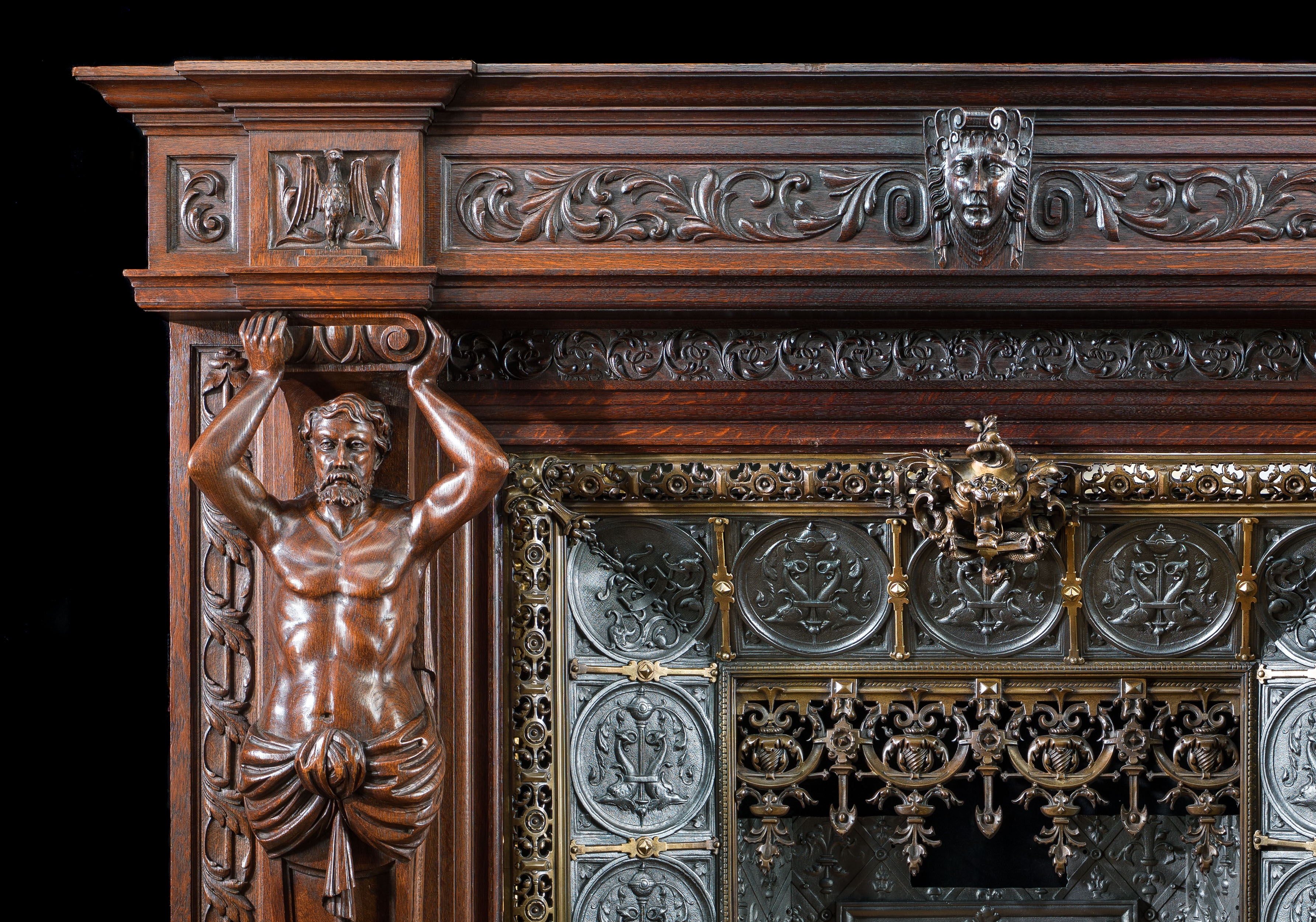 A large French carved Oak Renaissance style fireplace and insert.