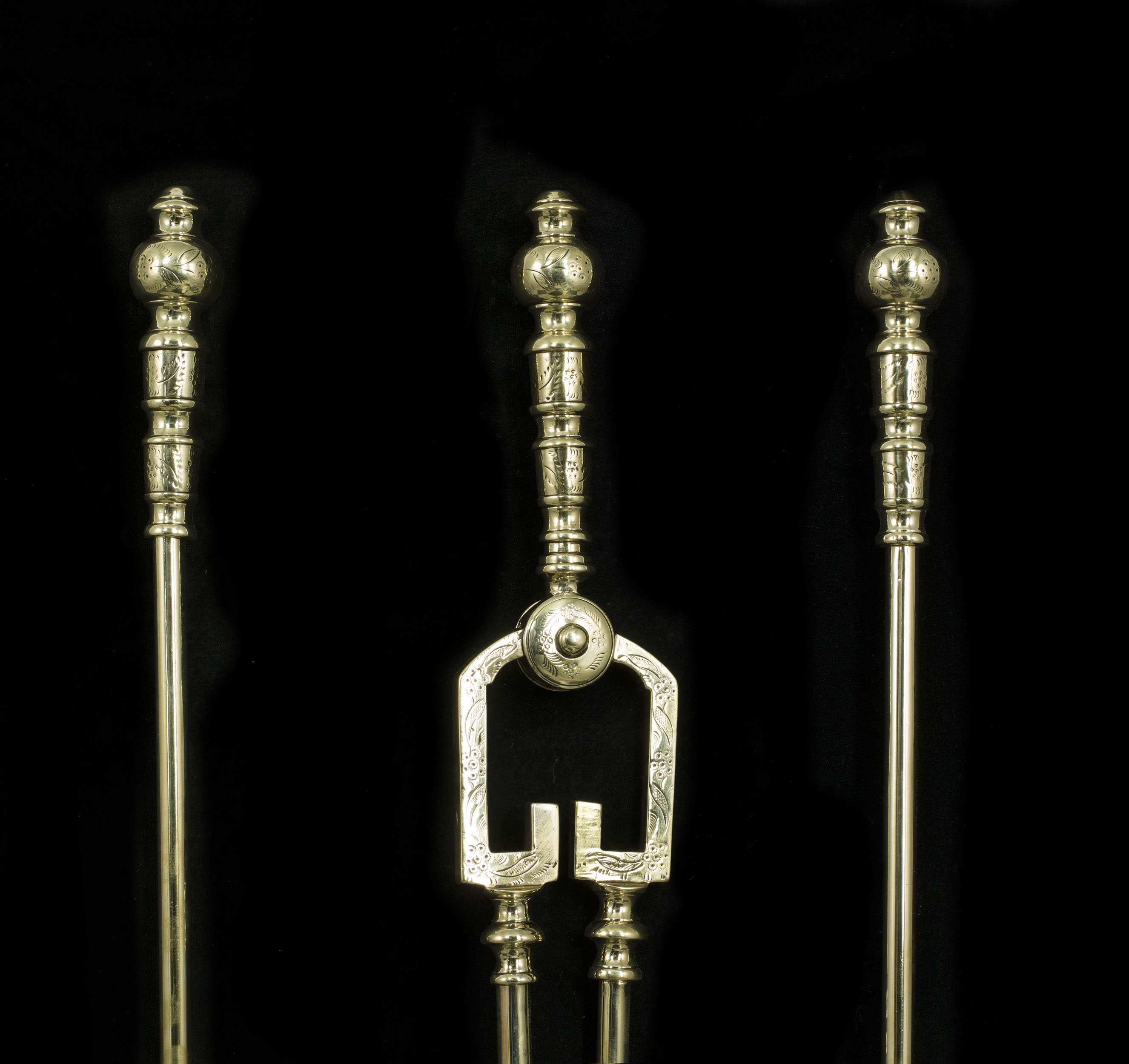A set of engraved Victorian Rococo style brass fire tools    