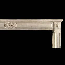 A Louis XVI Wide Limestone Chimneypiece
