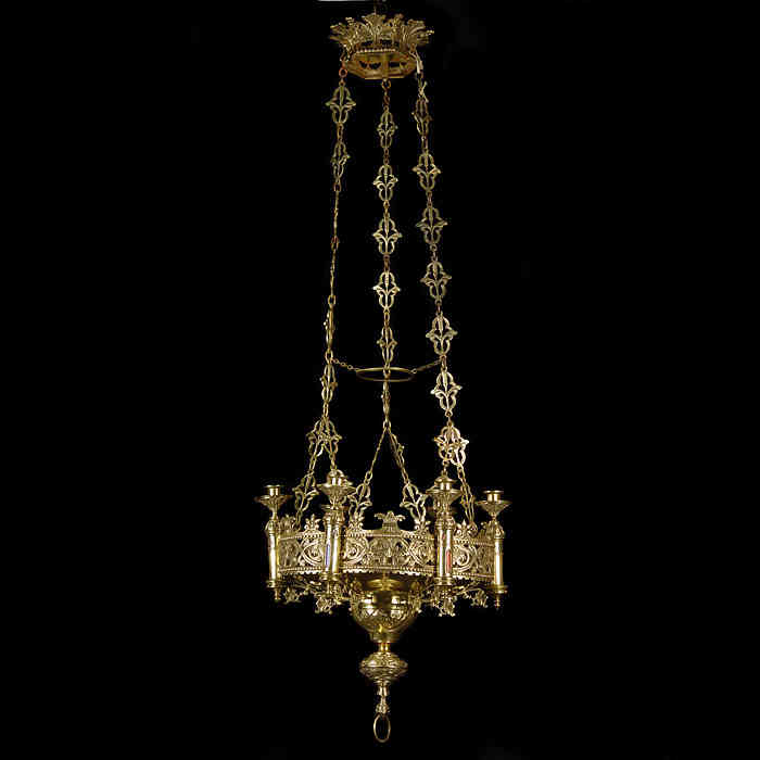Antique Gothic Revival manner gilt brass Chandelier with six raised sconces 
 An antique Gilt Brass hanging Chandelier in a Gothic Revival manner, French, with religious icons and a floral ceiling rose.

