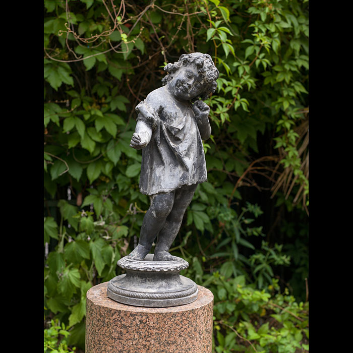 A lead garden figure of a listening child