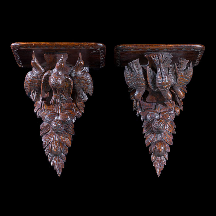 A near pair of Edwardian oak wall brackets