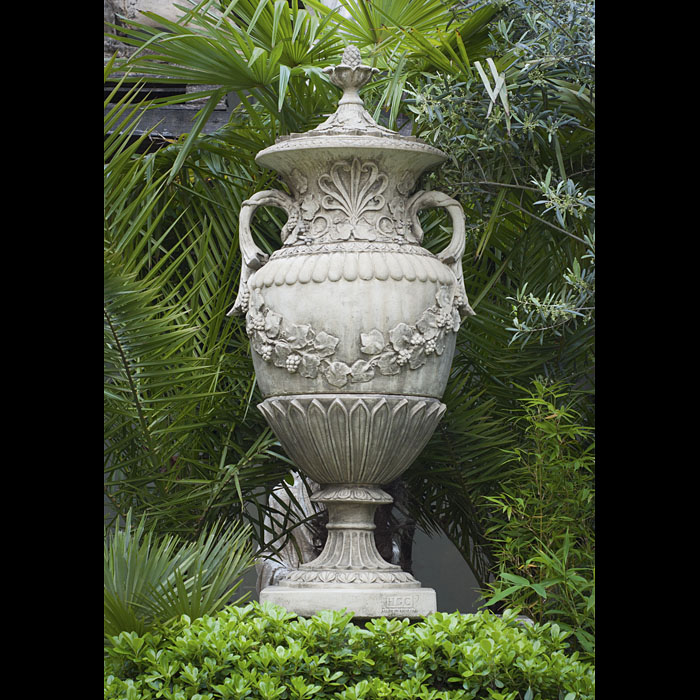 An ornate reconstituted 20th century French Baroque style lidded garden urn 