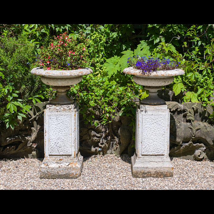 A Pair of Cast Iron Garden Urns on Plinths