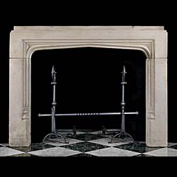 An antique Tudor style limestone fireplace surround 