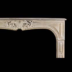 An antique rococo style limestone fireplace surround    