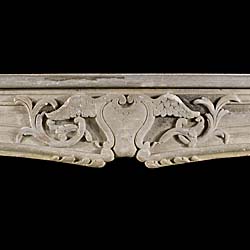 An antique rococo style limestone fireplace surround    