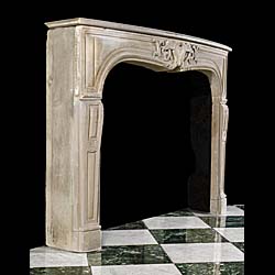 An antique rococo style limestone fireplace surround    