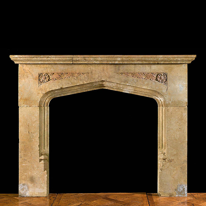 A carved stone 20th century fireplace mantel in the Tudor manner 