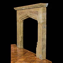 A carved stone 20th century fireplace mantel in the Tudor manner 