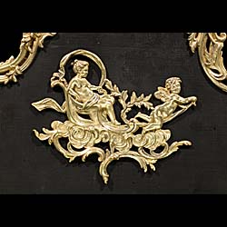 A Rococo style brass and mesh fire guard