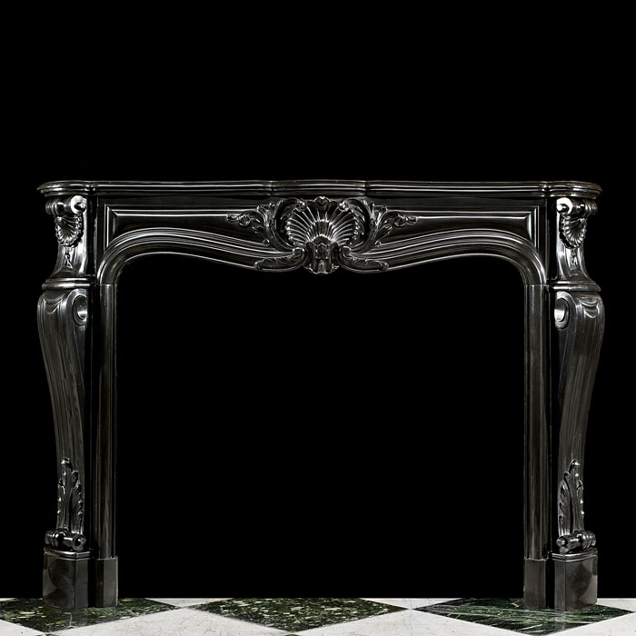 An elegant Belgian Black Marble French Louis XV style Rococo antique chimneypiece.