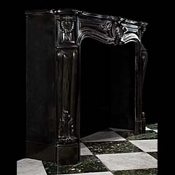 An elegant Belgian Black Marble French Louis XV style Rococo antique chimneypiece.