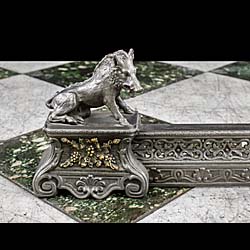 An antique French cast iron and brass boar fireplace fender 