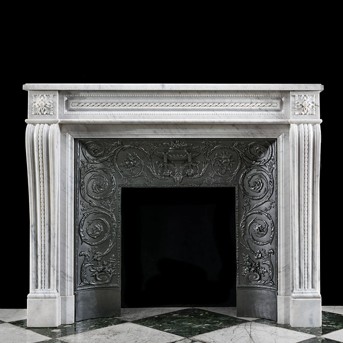 A French Louis XVI style antique marble fireplace and insert.