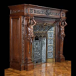 A large French carved Oak Renaissance style fireplace and insert.