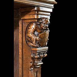 A carved walnut Gothic Revival fireplace and over mantel