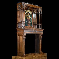 A carved walnut Gothic Revival fireplace and over mantel