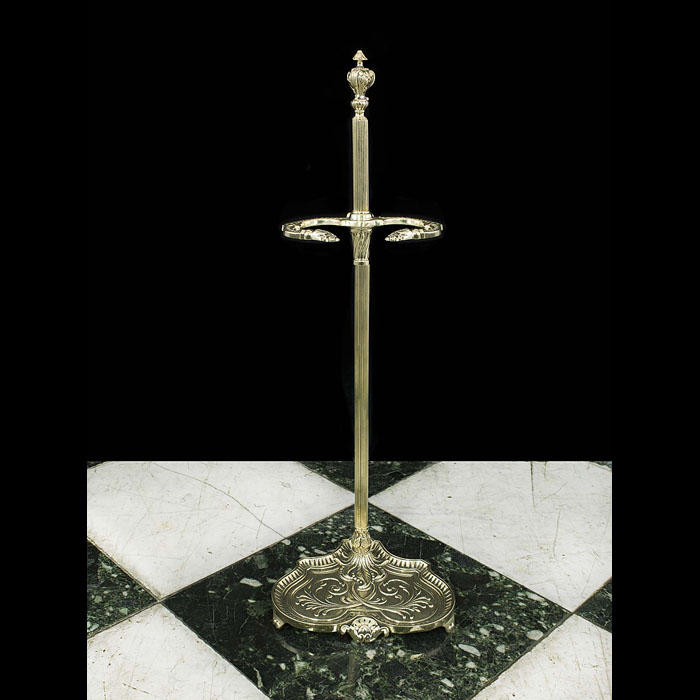 An antique brass fire tool stand with a reeded shaft    