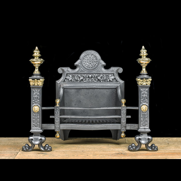 A Baroque style iron and brass firegrate