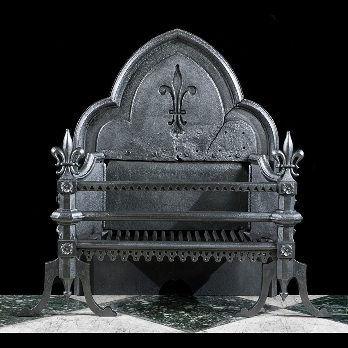 A large cast iron Gothic Revival fire grate