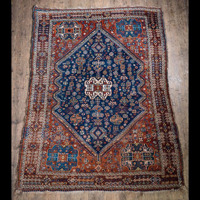 A Qashqai midnight blue & red tribal carpet.