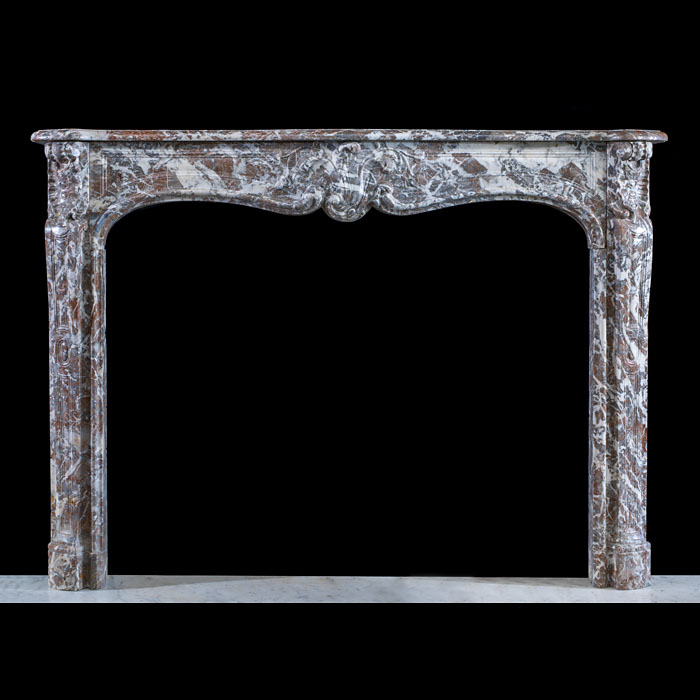 A Louis XV Languedoc Marble Fireplace