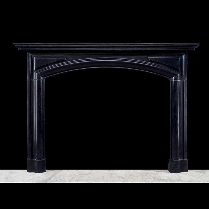 A Fine French Arched Black Marble Bolection Fireplace